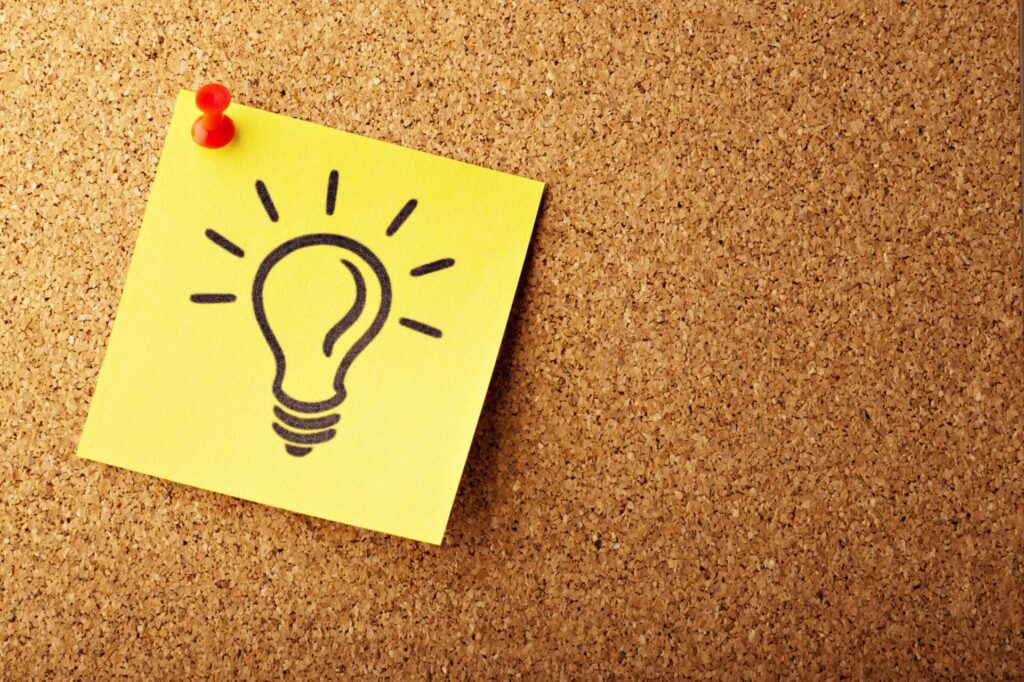 A post it note with a light bulb written on it