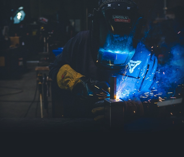 A manufacturing worker using equipment
