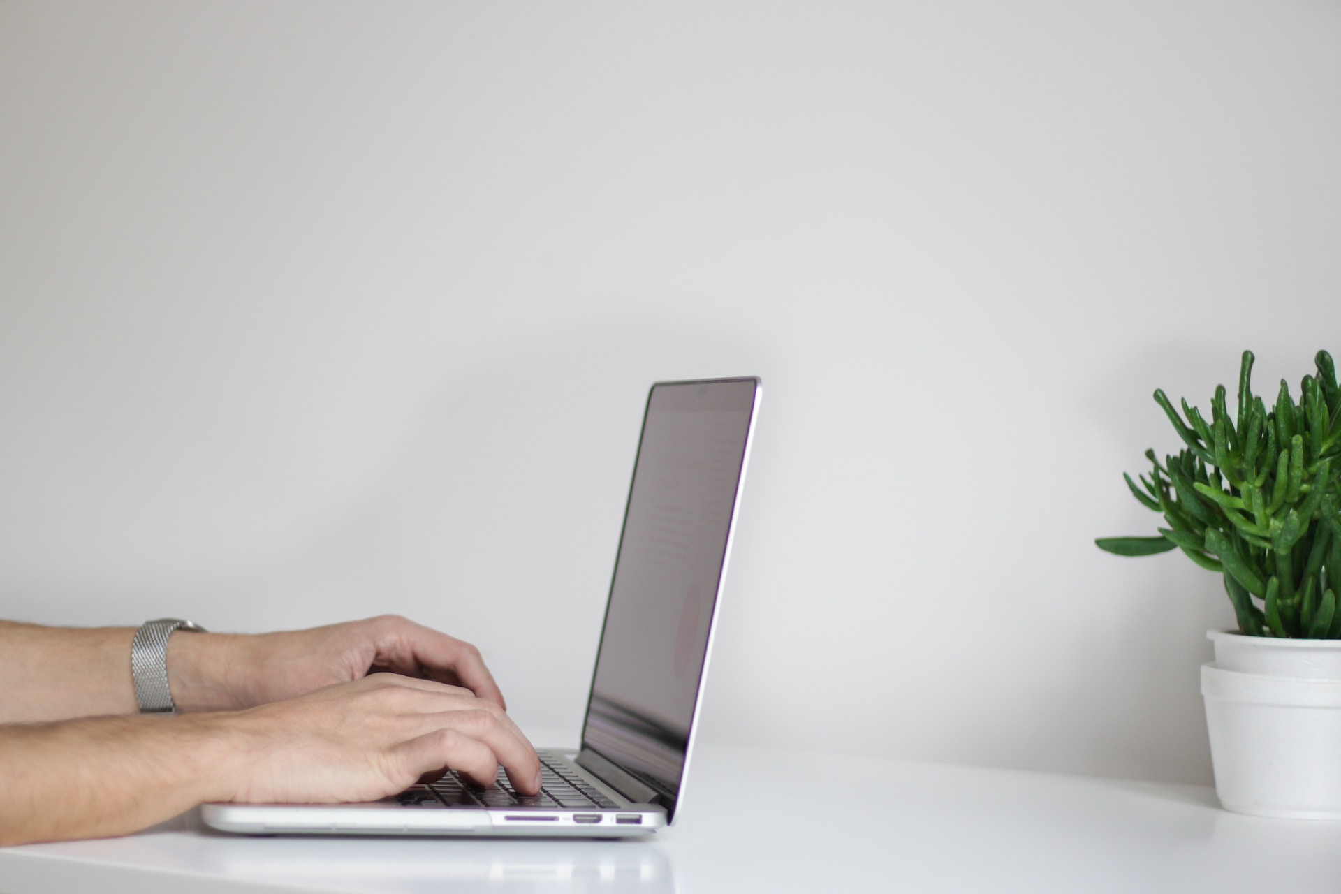 A man typing on his laptop