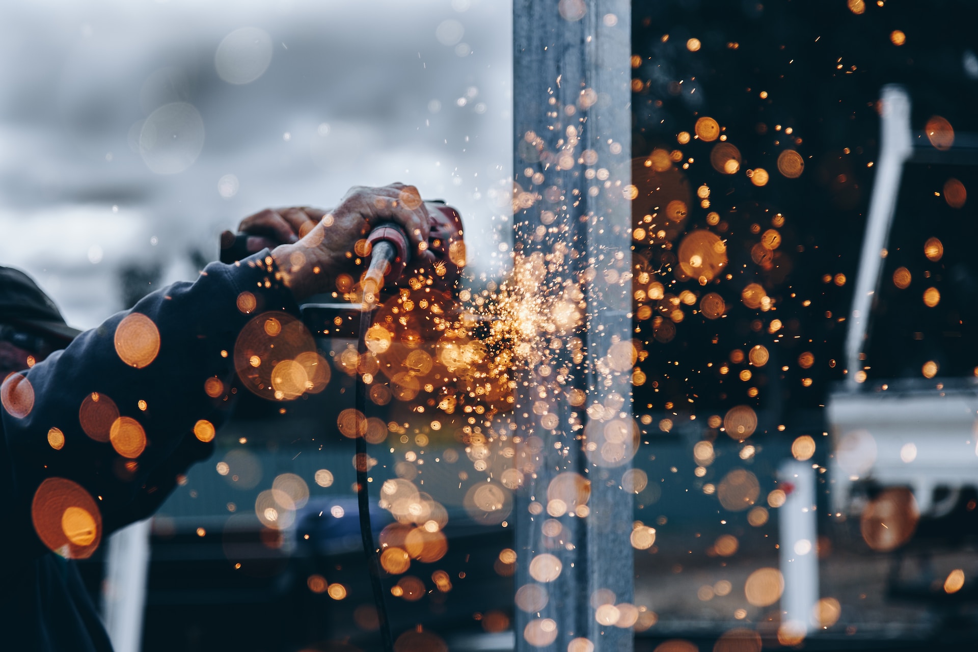 A construction worker using a grinder.