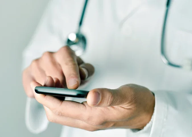 A doctor on a smart phone