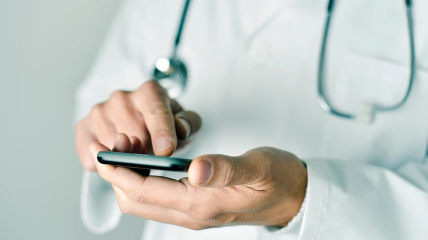 healthcare 1920x1080 A doctor on a smart phone