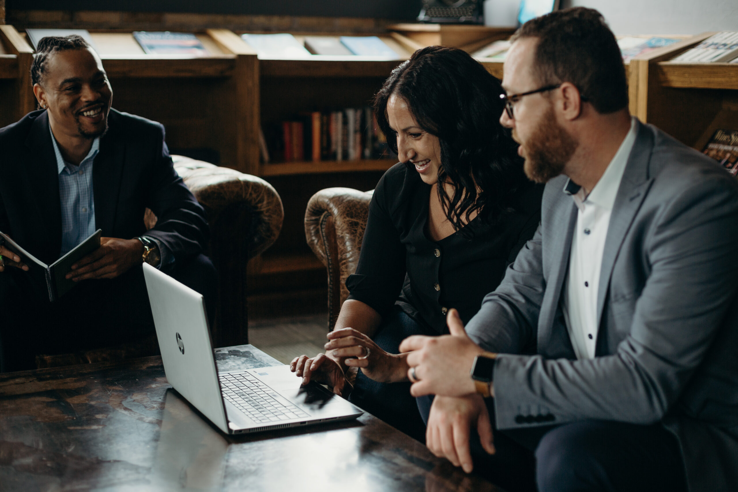 Three recruiting consultants at Titus Talent Strategies working together on a project.