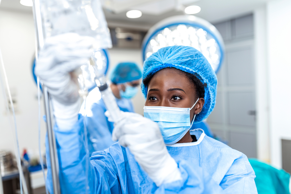 A doctor checking the fluid levels on an IV.