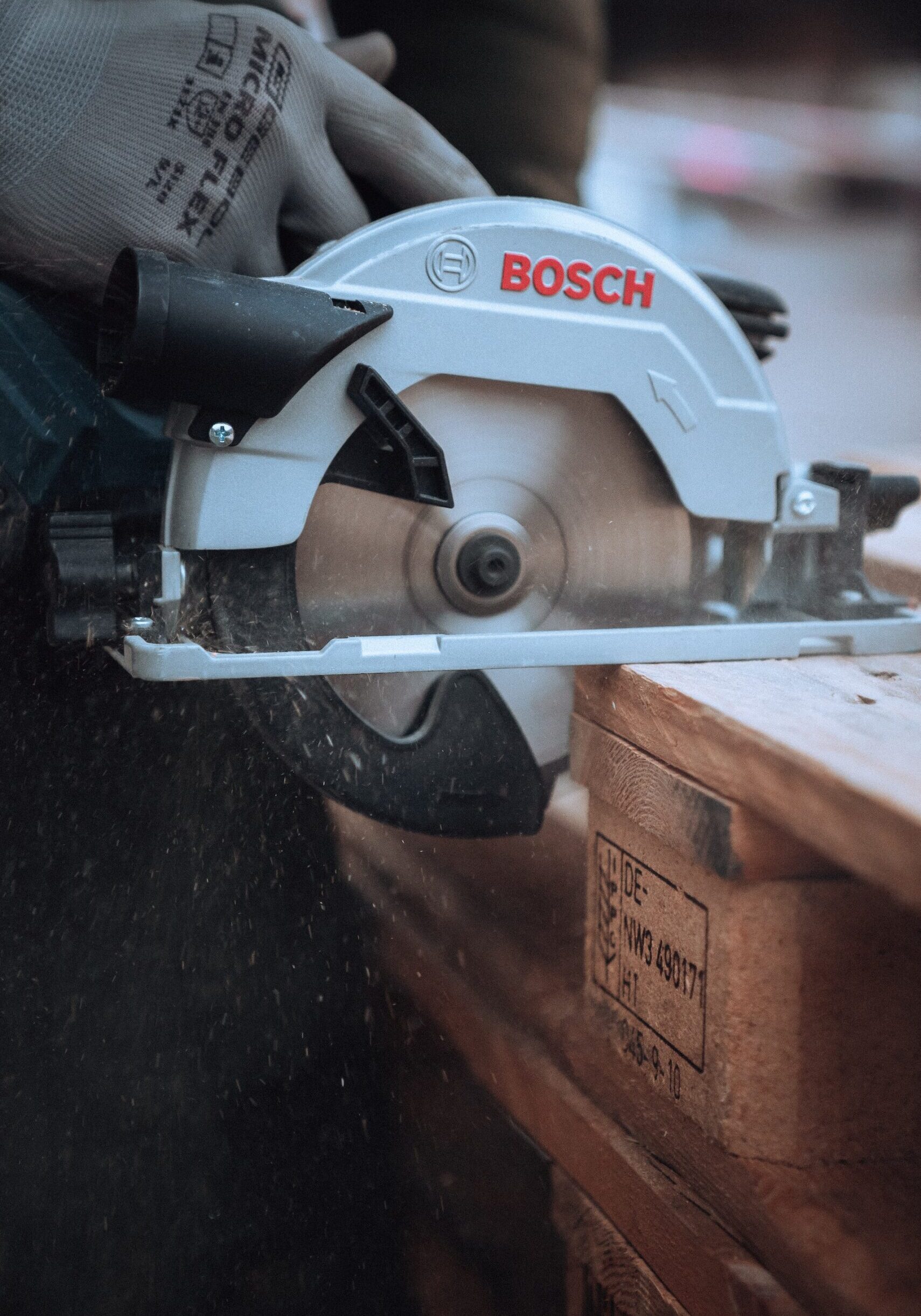 A construction worker using a bosch saw